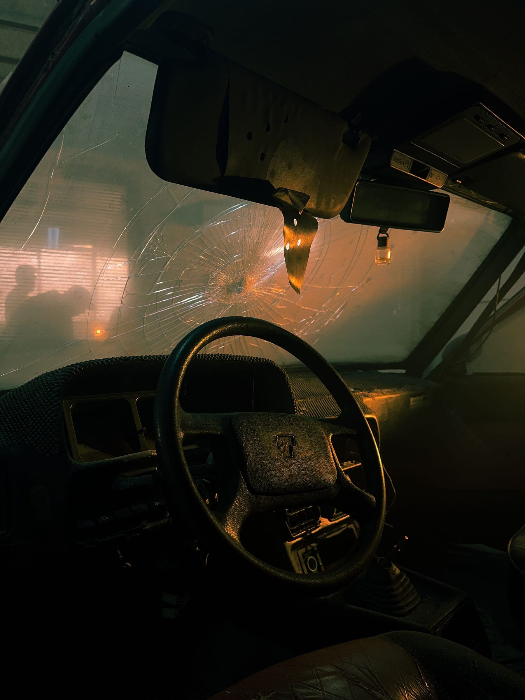 Windshield repair in Billings, MT: cracked windshield seen from the driver seat at dusk