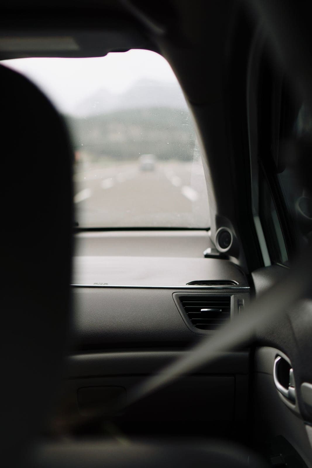 Open road seen through the windshield from the back seat