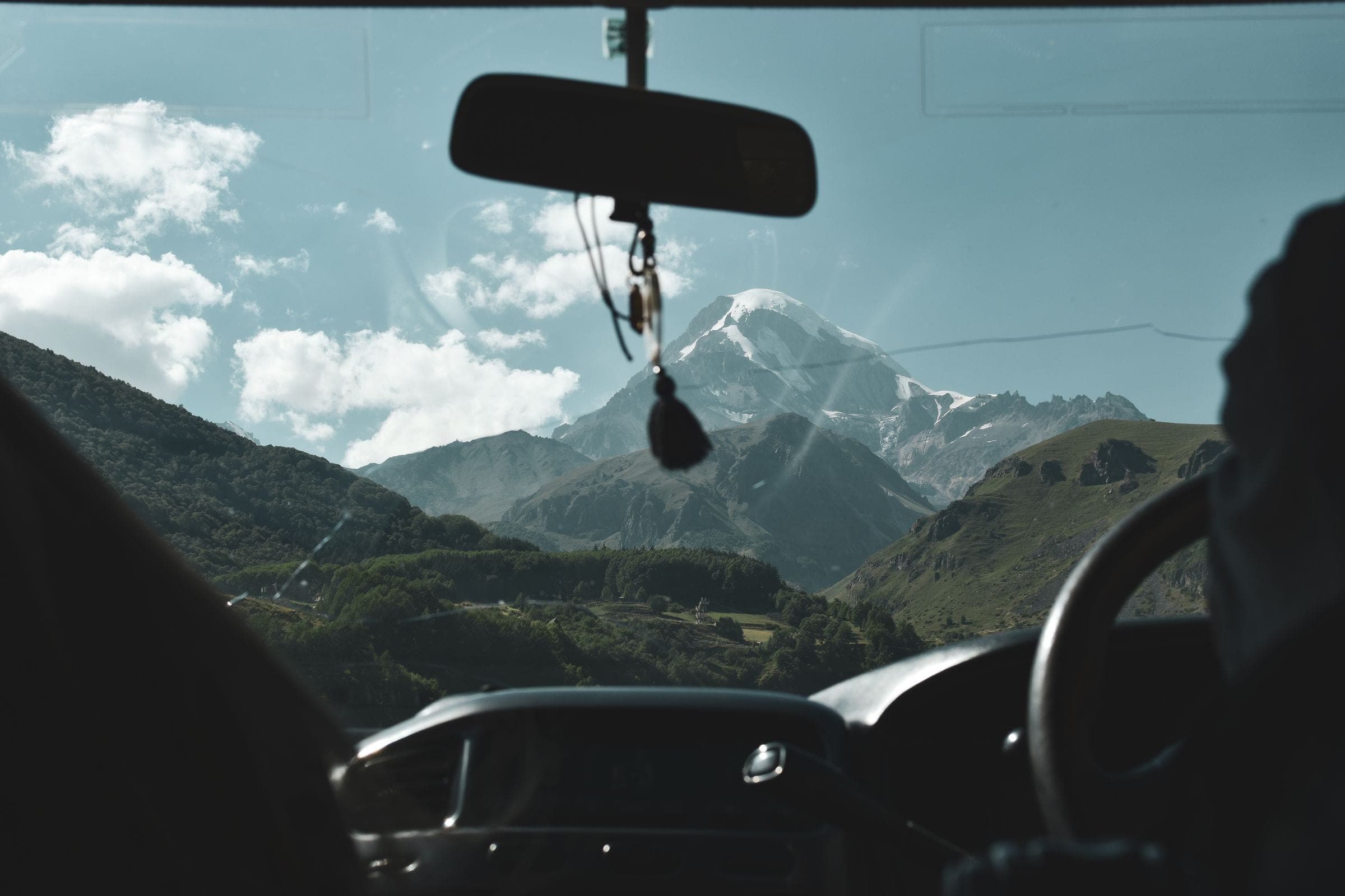 Auto glass services in Billings: mountain road seen through a clean windshield