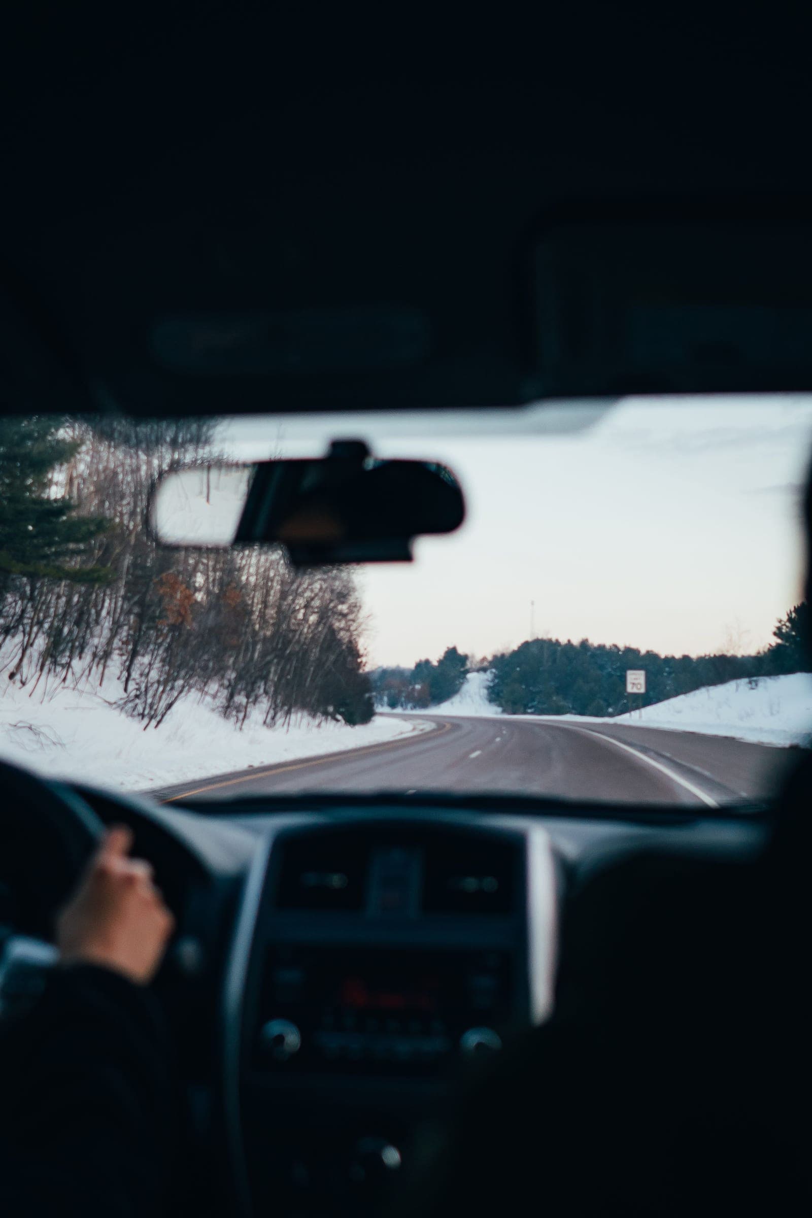 Winter highway seen from the driver seat through the windshield